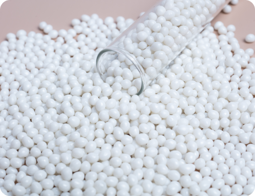 Recycled white plastic pellets, a raw material used in various industries for manufacturing and production. 